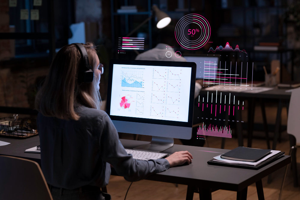 woman looking at visual reports on monitor